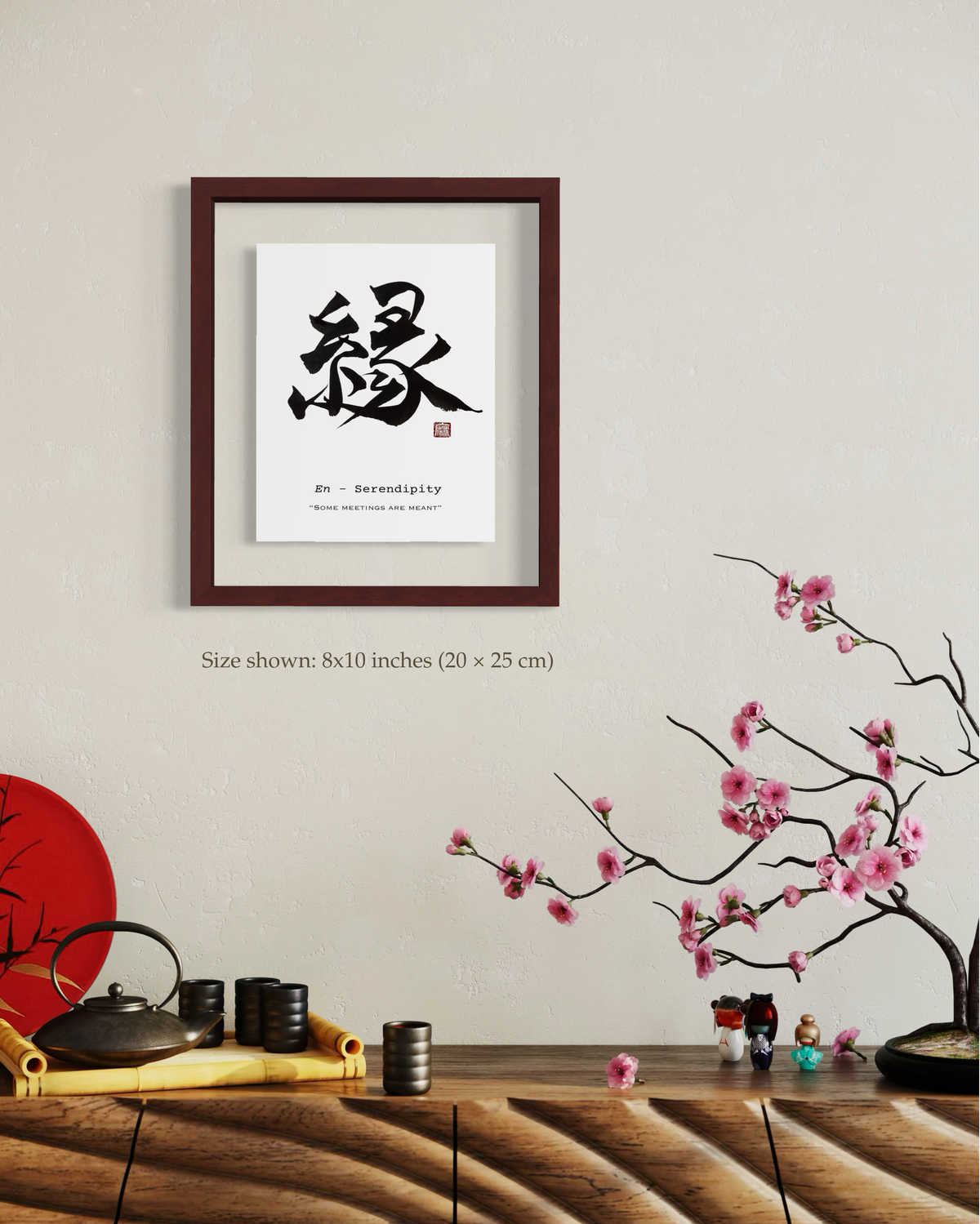 Framed 縁 (En, serendipity) Japanese calligraphy print on a wall with soft decorative accents.