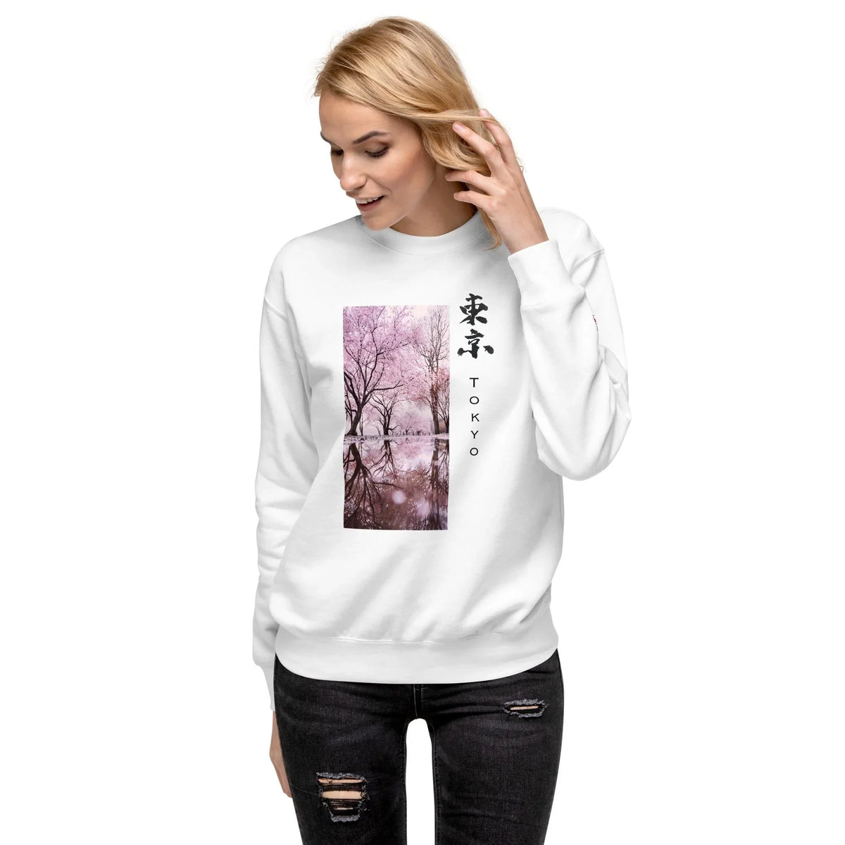Woman wearing white sweatshirt with cherry blossom Tokyo art and Japanese calligraphy print
