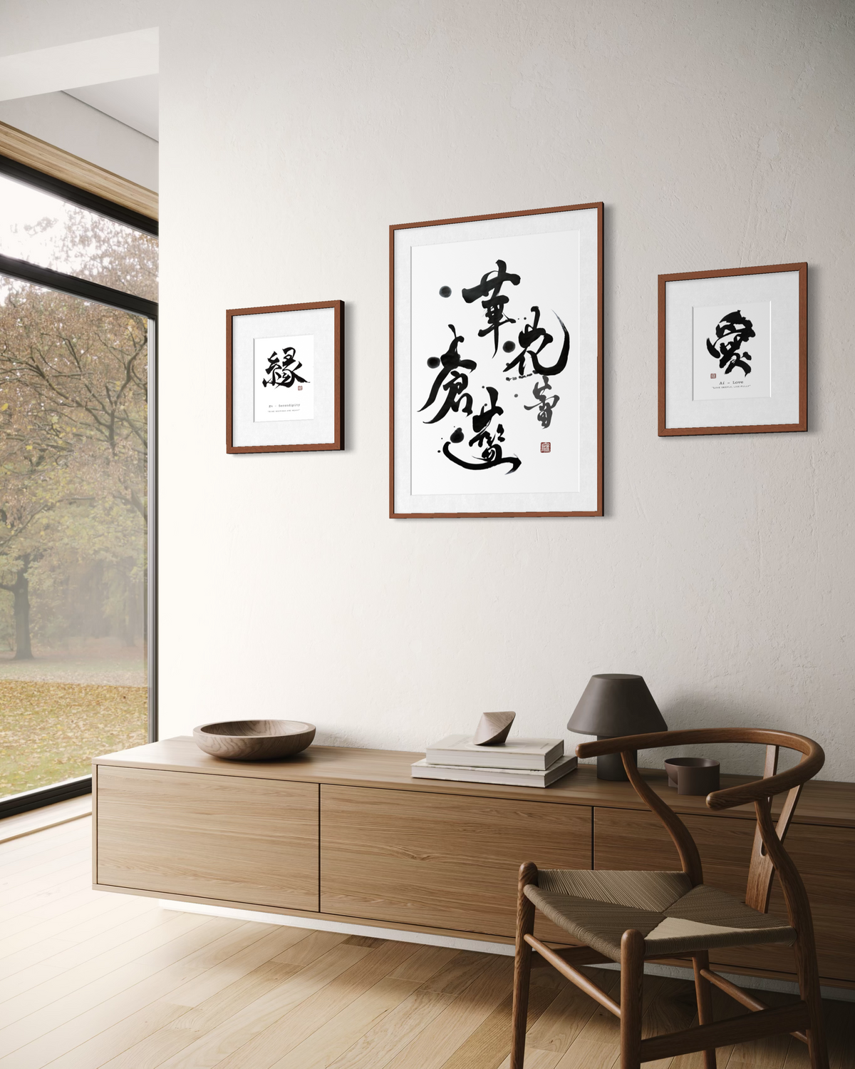 Minimalist Japanese calligraphy wall art with 'Laugh' kanji, framed, beside a vase with branch