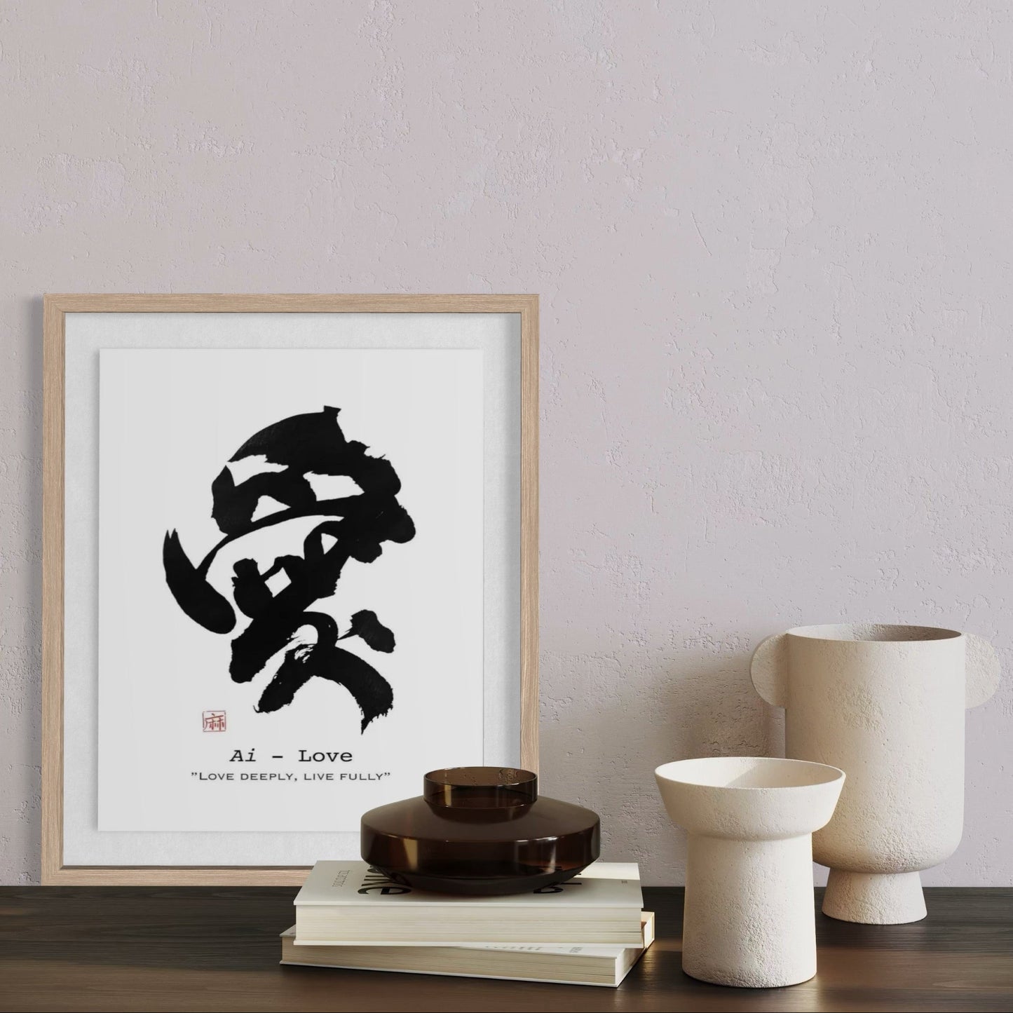 Framed black calligraphy artwork on a wall with decorative items below.