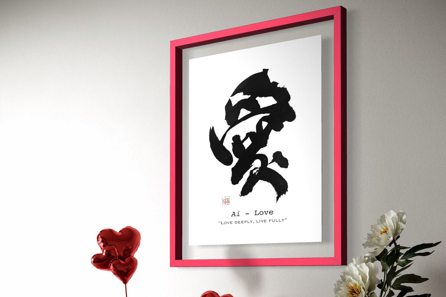 Framed artwork with a black and white design on a red cabinet with decorative items.